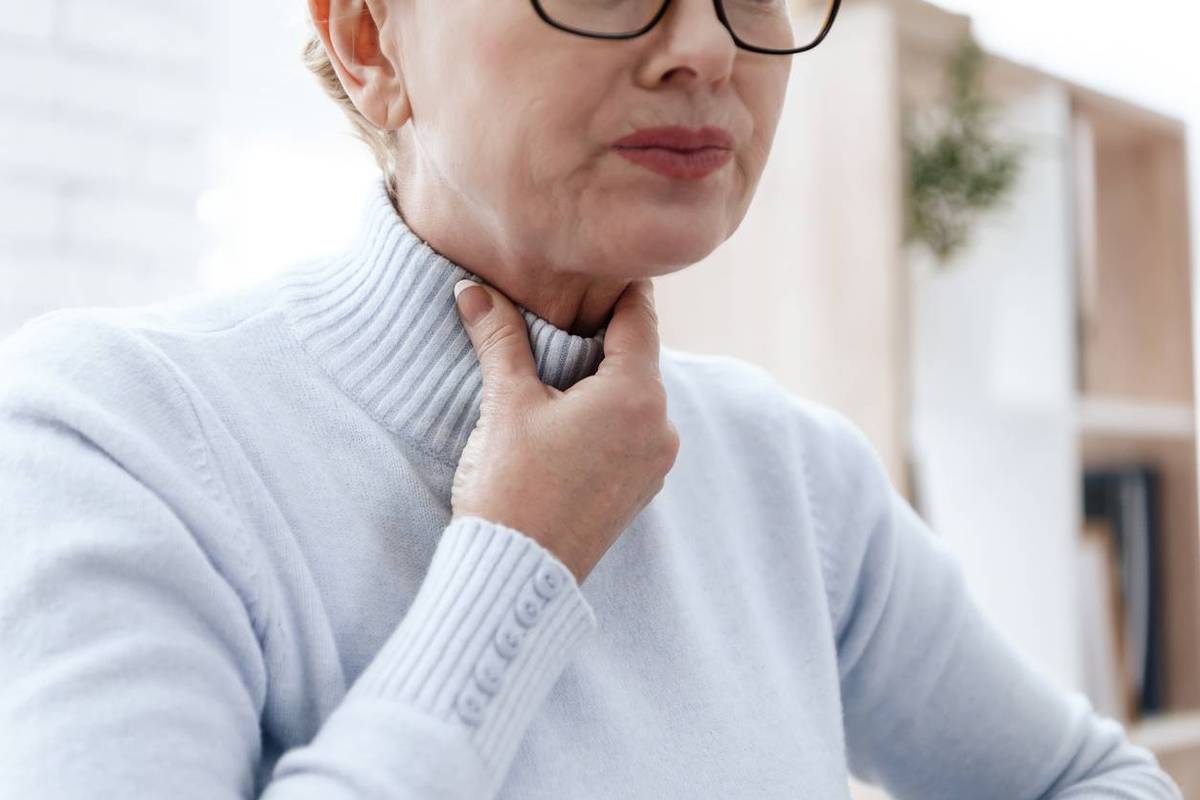 woman suffering from EOE with throat pain
