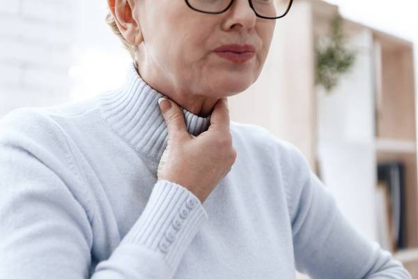 woman suffering from EOE with throat pain