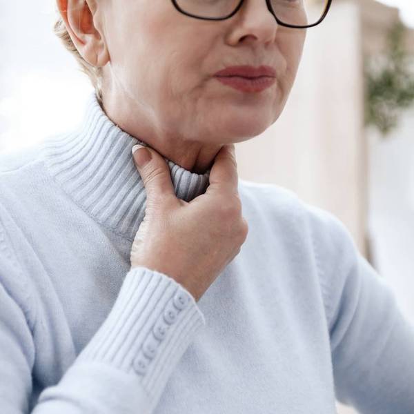 woman suffering from EOE with throat pain