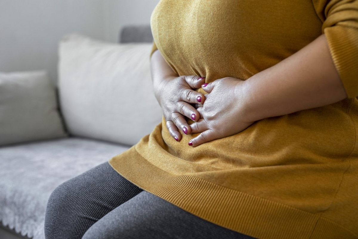 woman suffering from IBS holding her stomach