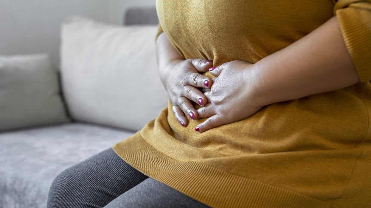 woman suffering from IBS holding her stomach