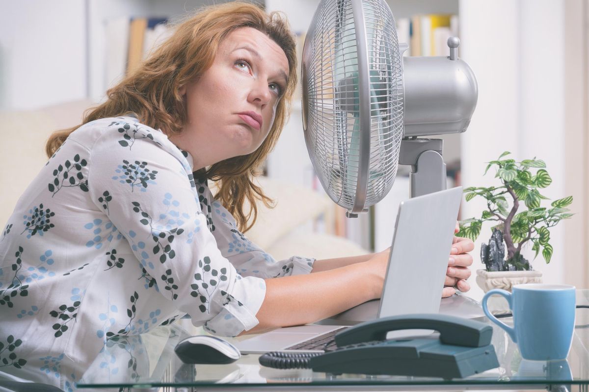 woman suffers from heat in the office