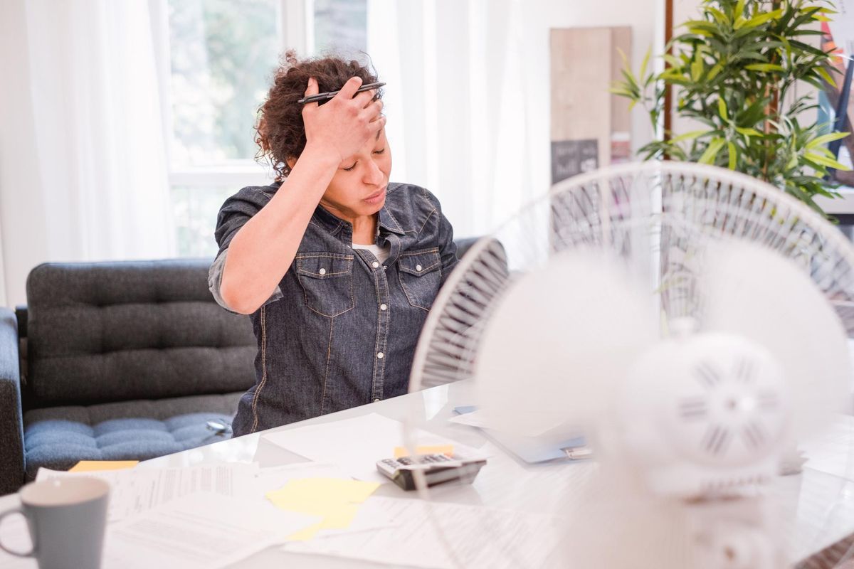 Woman sweating and suffering from a hot flash