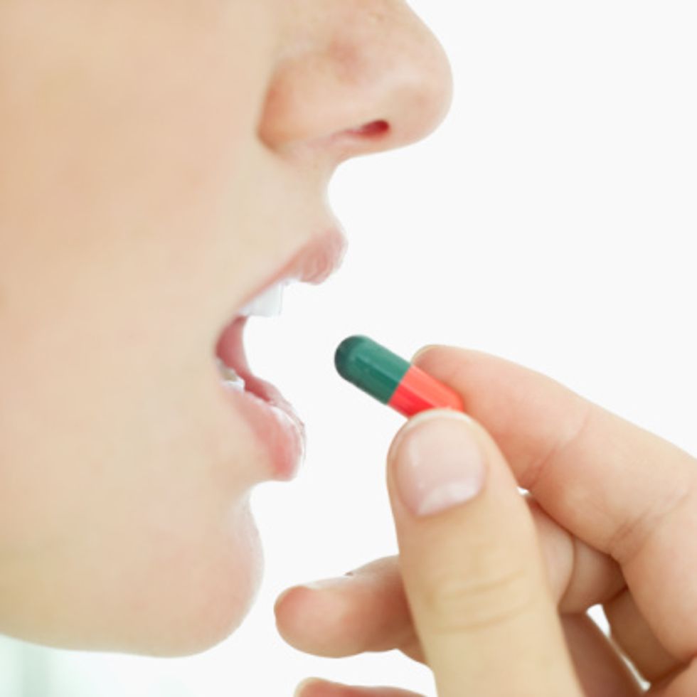woman taking a pill