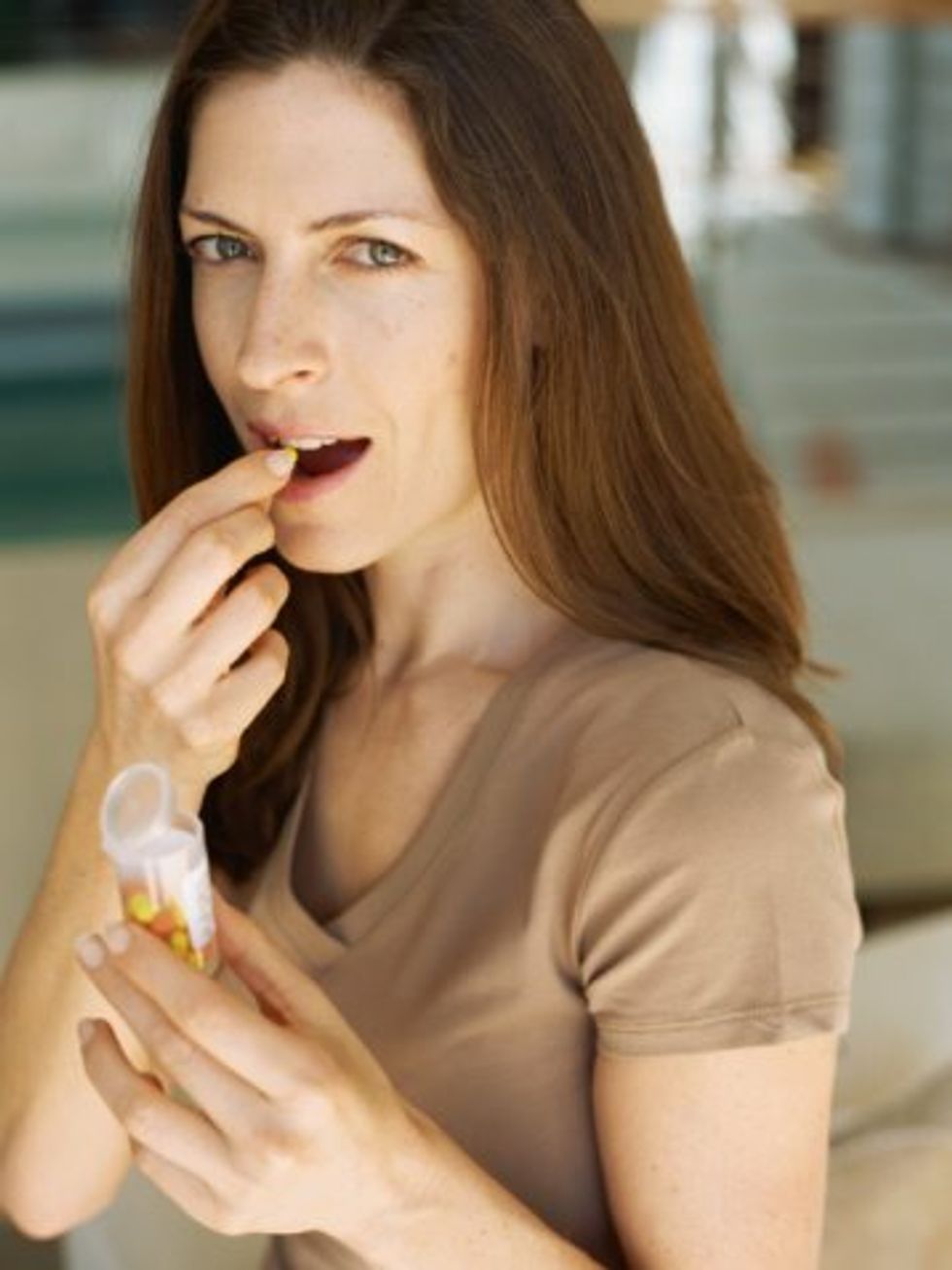 woman taking an aspirin