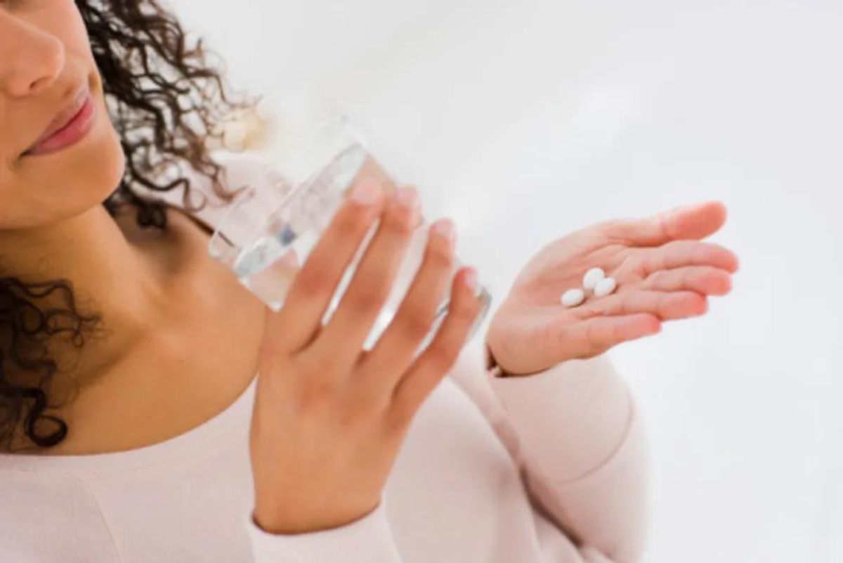 woman taking pills