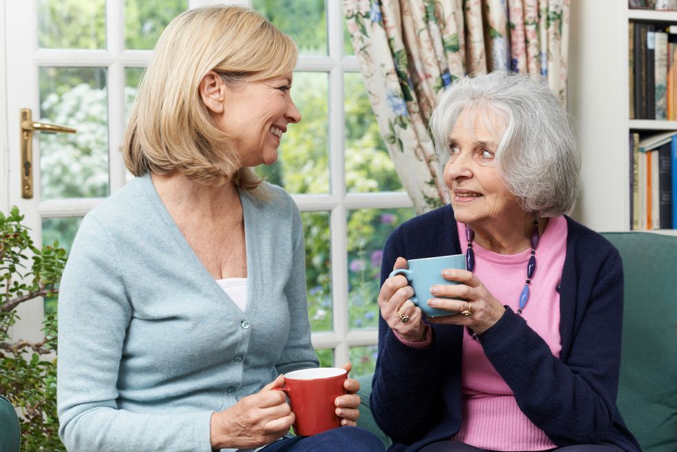 Woman Taking Time To Visit Senior Female Neighbor And Talk