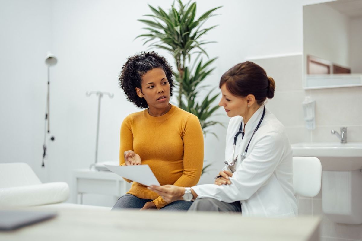 woman talking to doctor about participating in a clinical trial