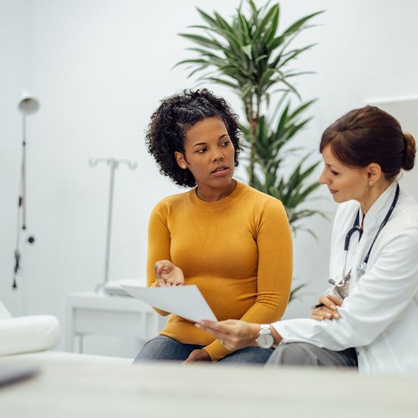 woman talking to doctor about participating in a clinical trial