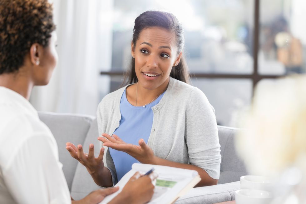 woman talking with her doctor about preventive screenings