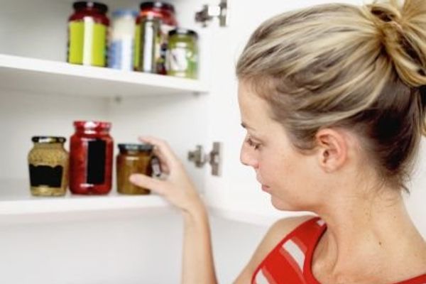 woman tidying up kitchen pantry