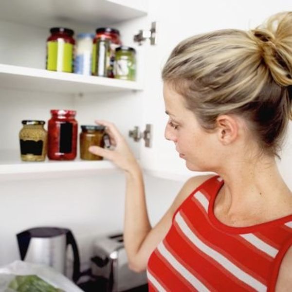 woman tidying up kitchen pantry