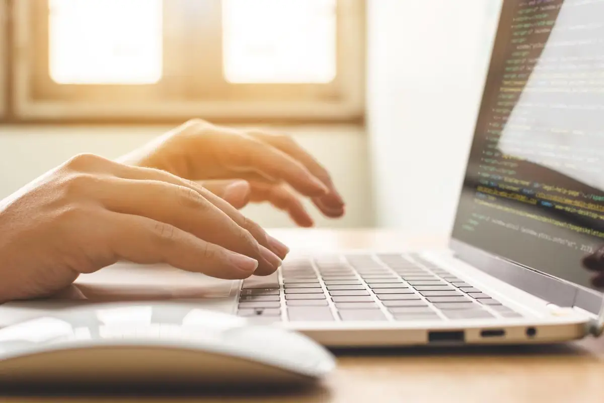 woman typing on a laptop