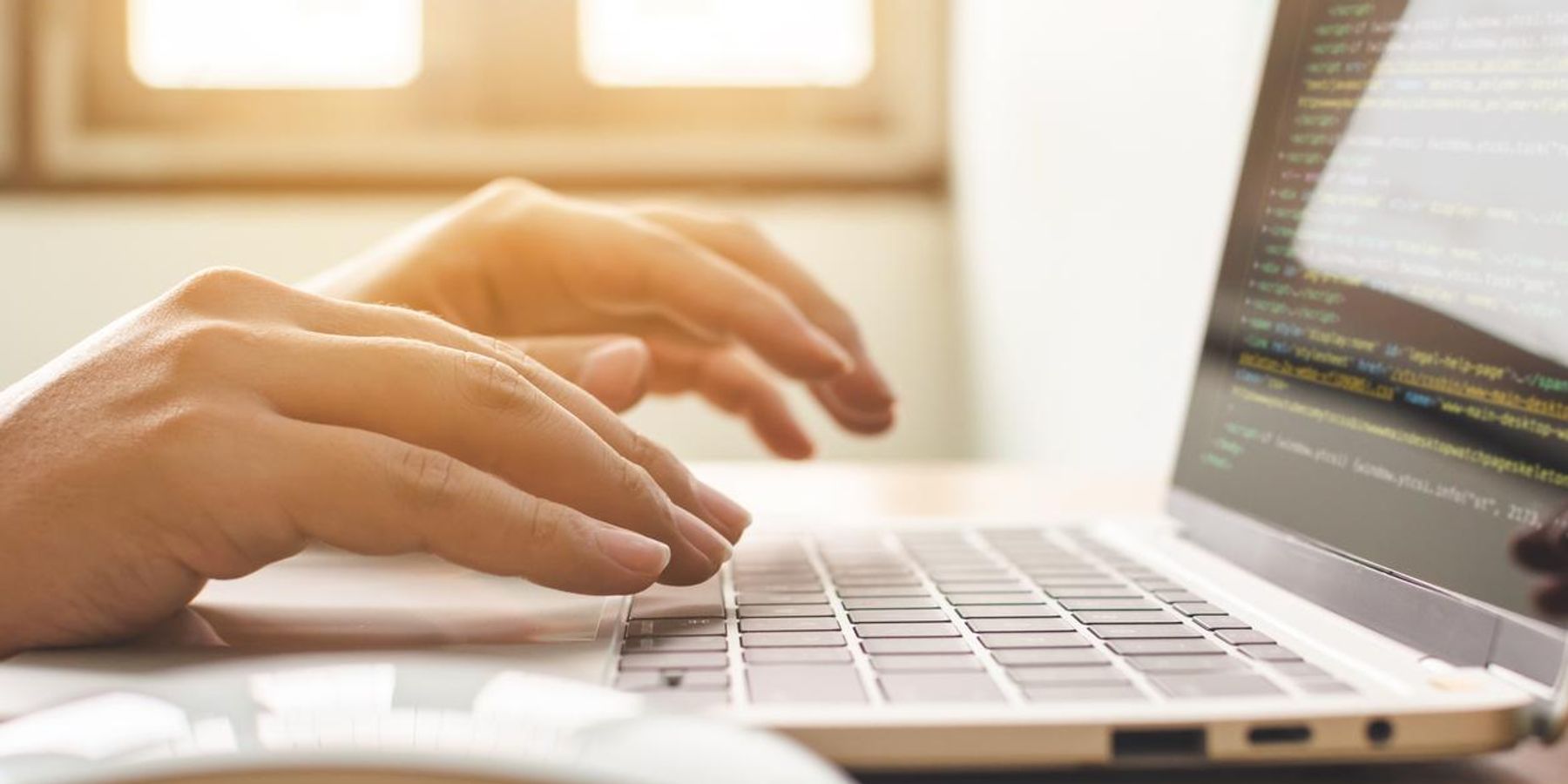 woman typing on a laptop