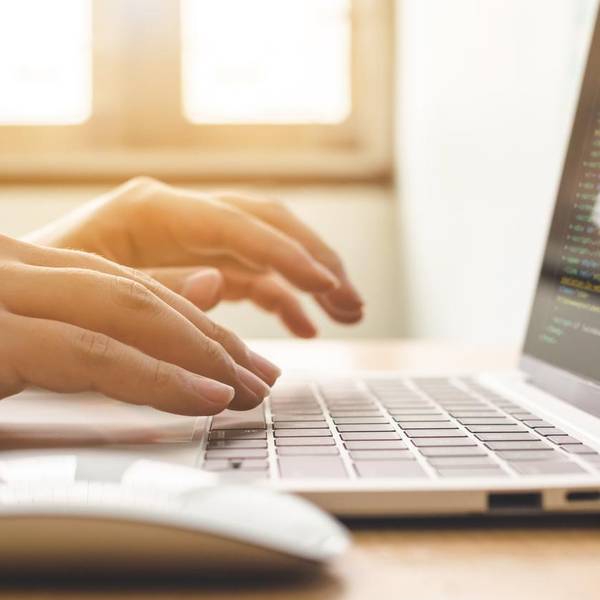 woman typing on a laptop