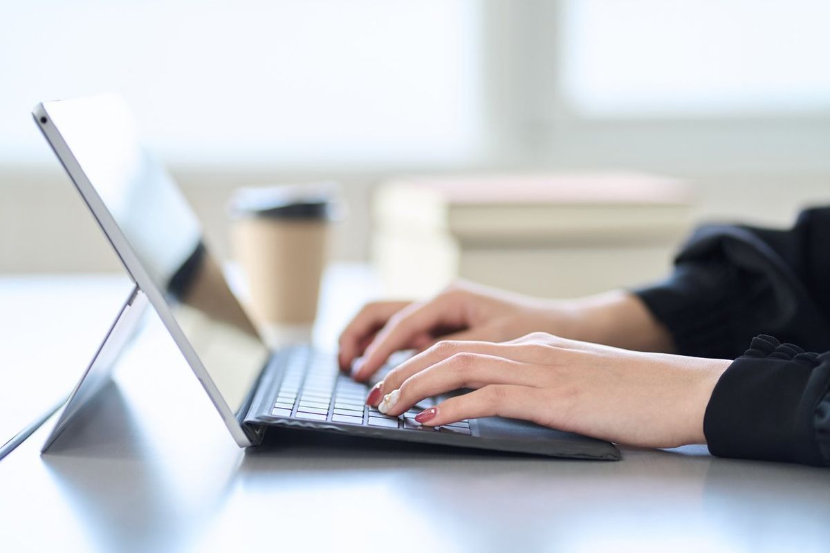 woman typing on laptop