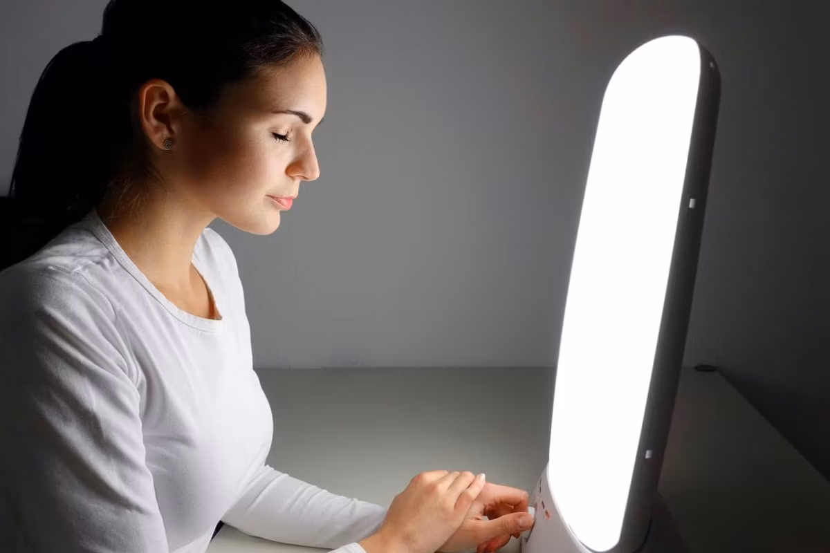 woman using Light therapy lamo at home for SAD Light Therapy