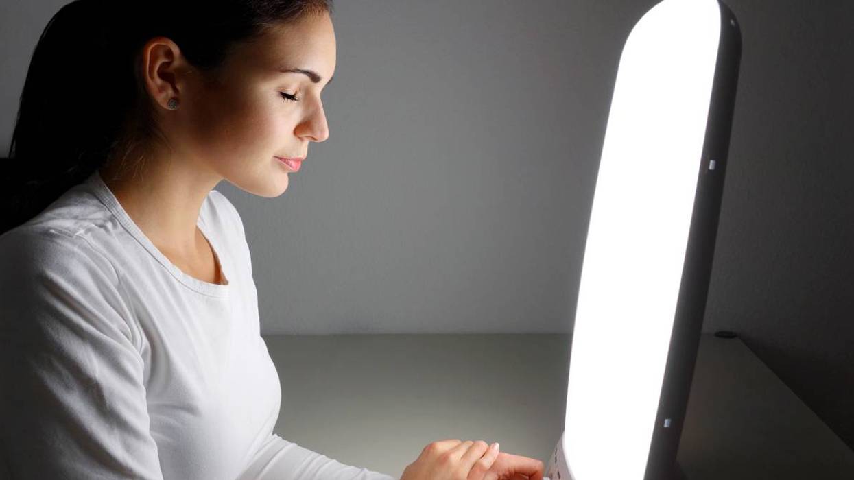 woman using Light therapy lamo at home for SAD Light Therapy