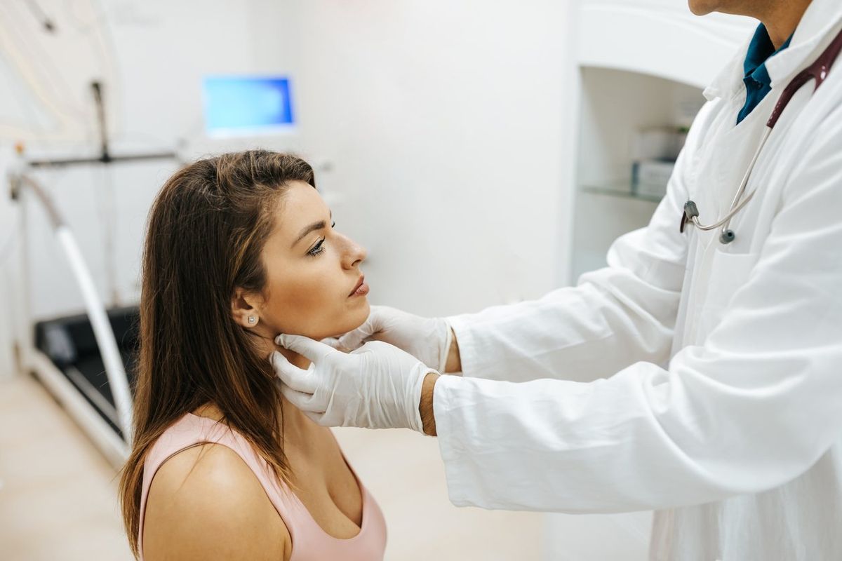 woman visiting general practitioner due to soreness and pain in her throat