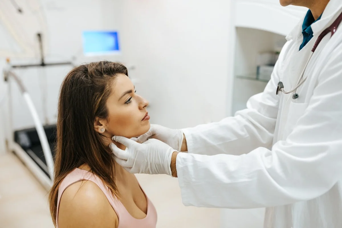 woman visiting general practitioner due to soreness and pain in her throat