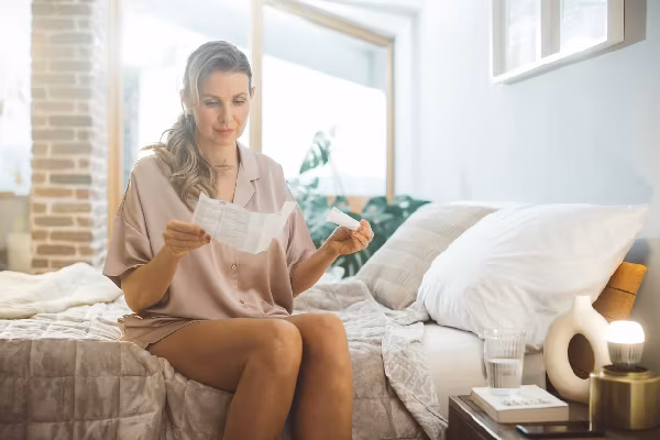 woman waking up and using products for hormone replacement therapy