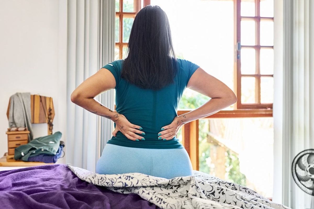 Woman waking up in the morning suffering backache