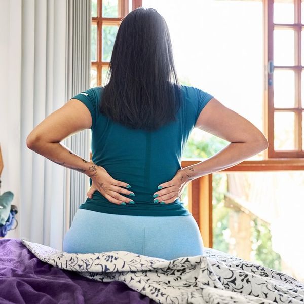 Woman waking up in the morning suffering backache