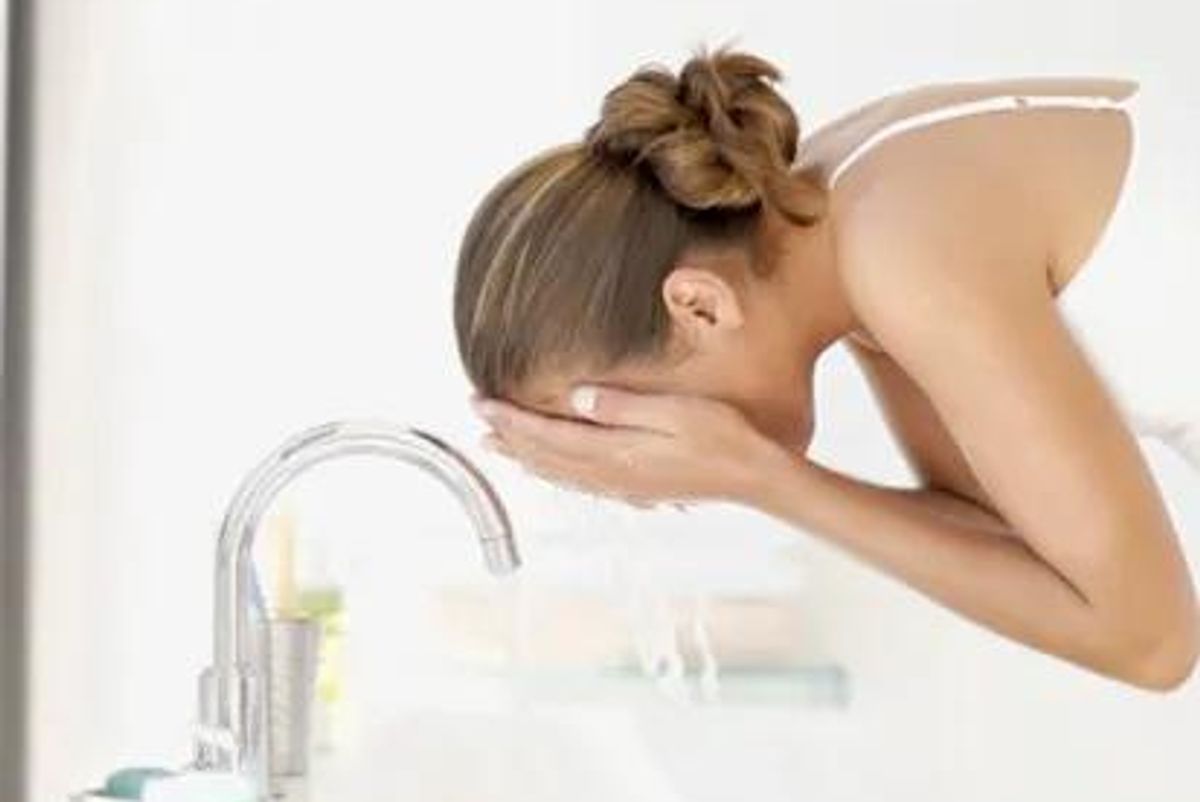 woman washing her face