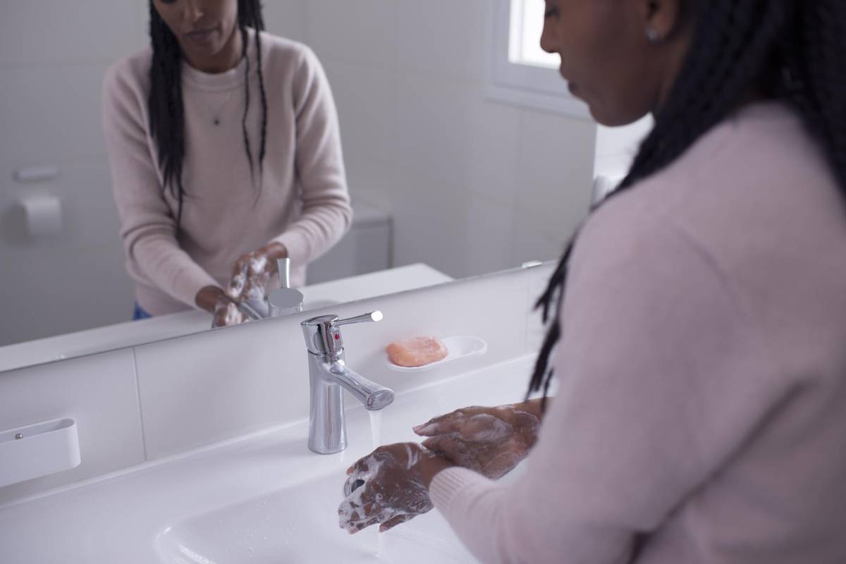 woman washing her hands with soap