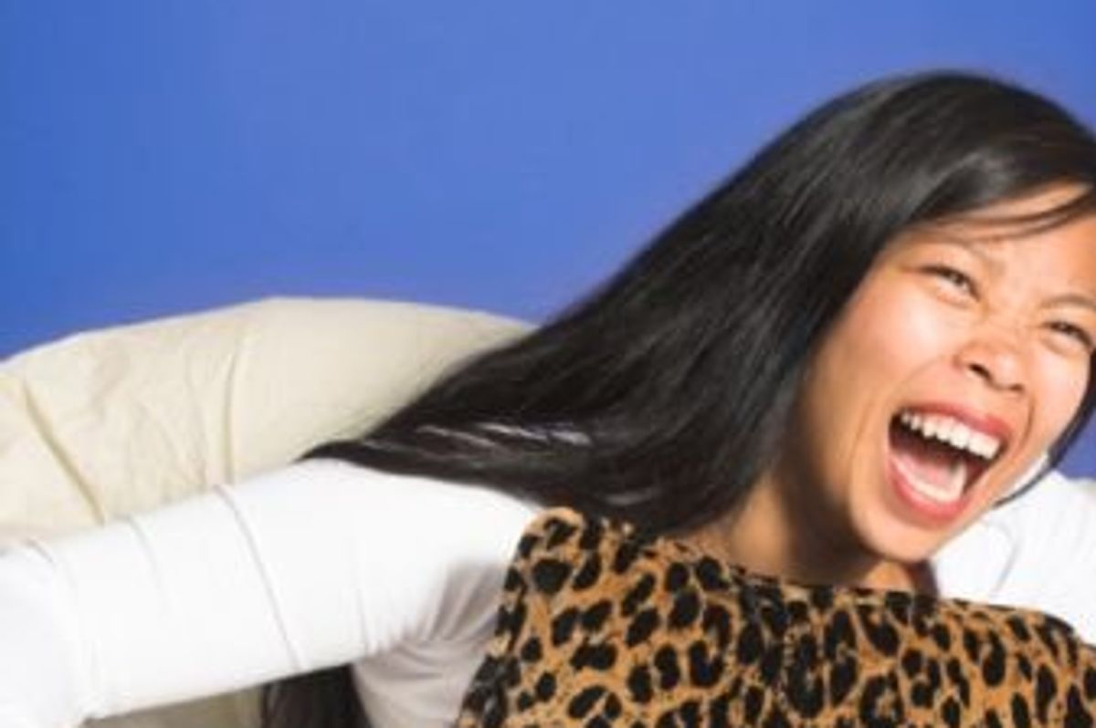 woman watching tv and laughing