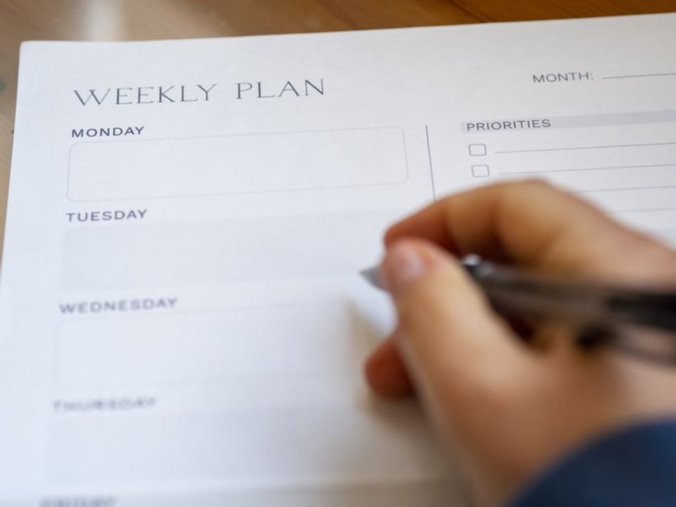 Woman weekly planning on daily schedule