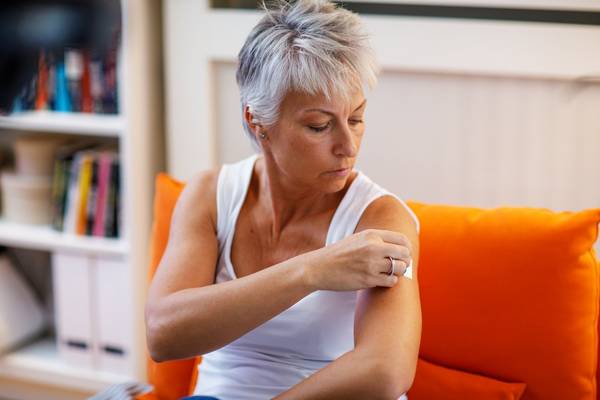 woman with an estrogen patch on her arm