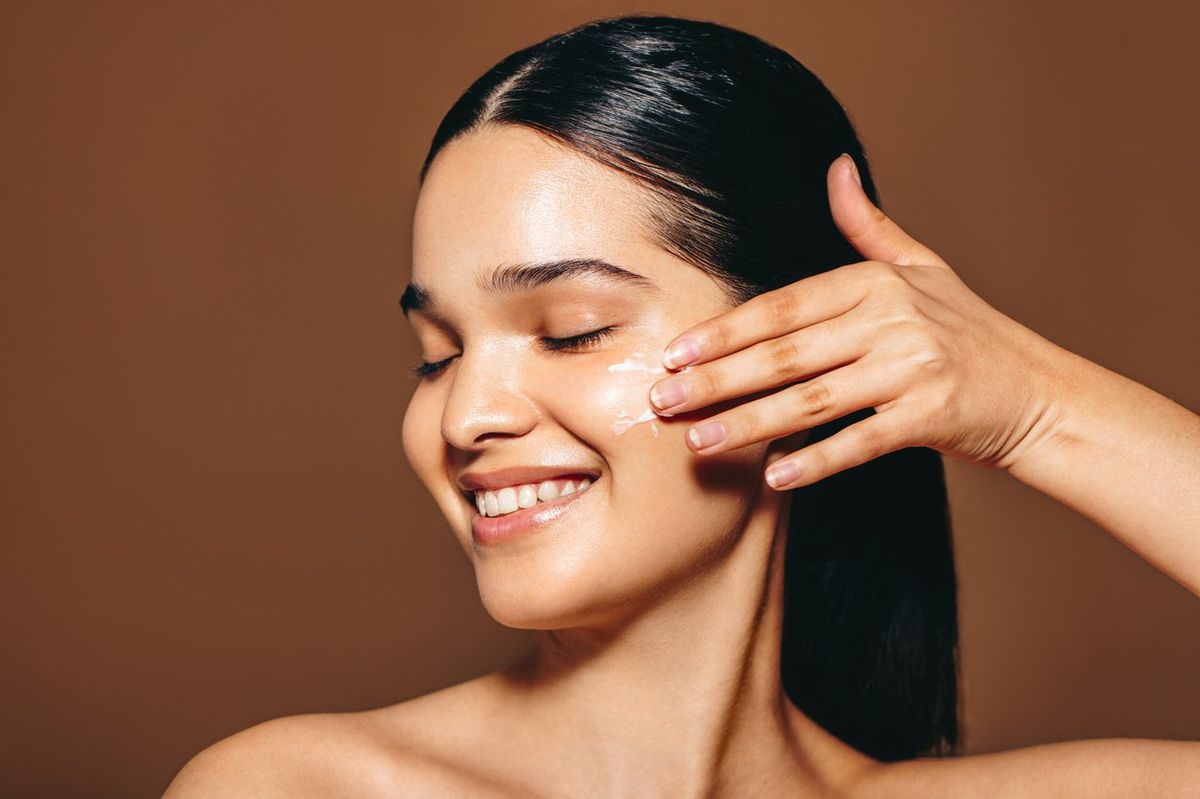 woman with applies facial cream