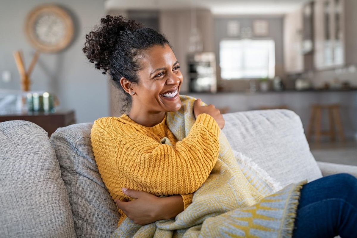 woman with blanket on couch