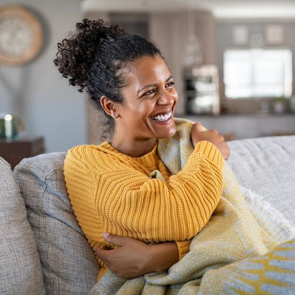 woman with blanket on couch