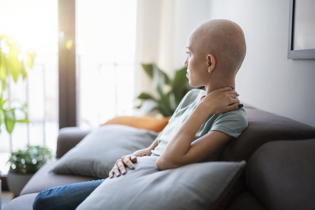 Woman with cancer contemplating and relaxing at home