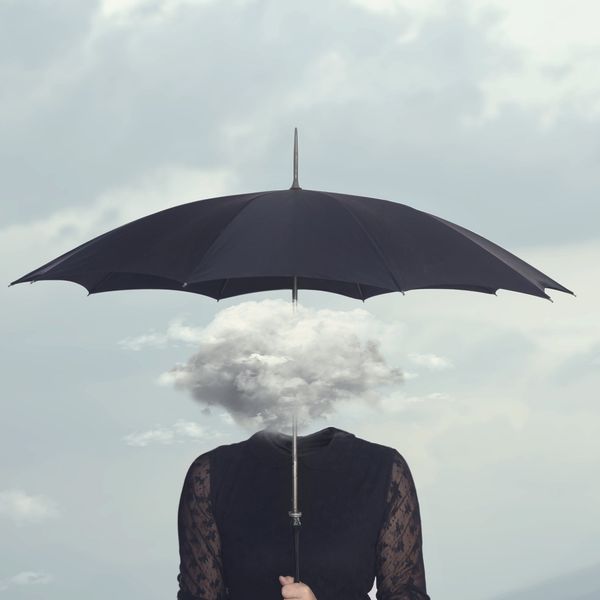 woman with cloud head sheltering herself from the rain with umbrella