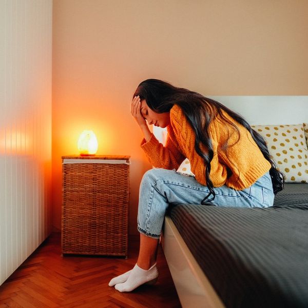 Woman with endometriosis pain staying home