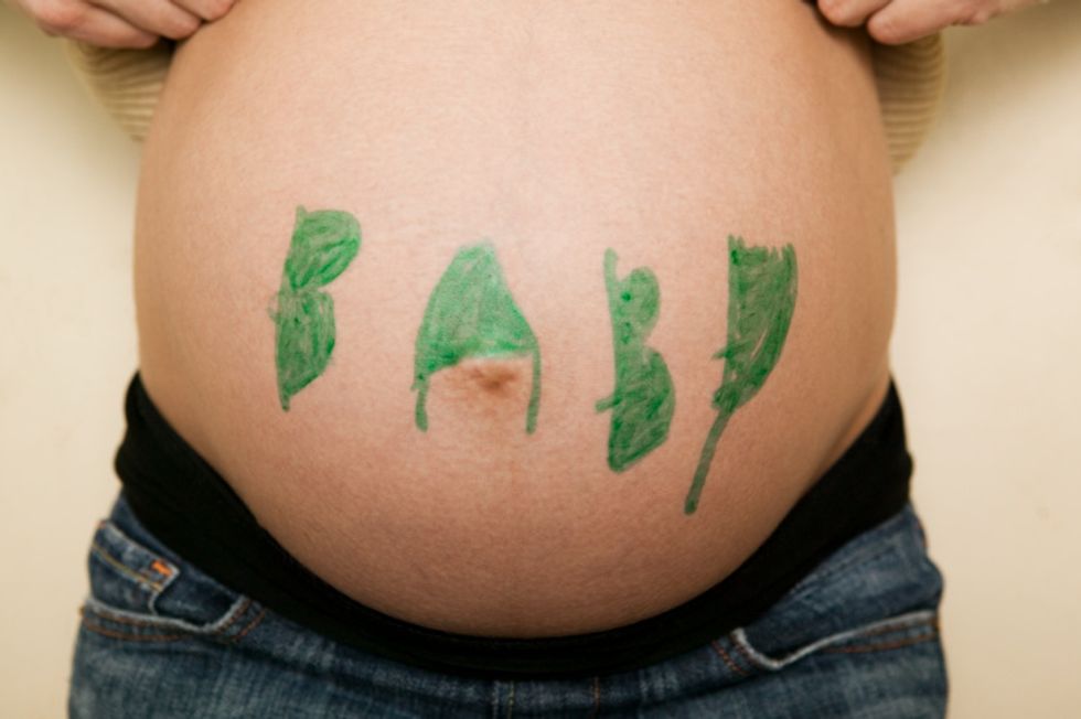 woman with the word baby on her pregnant belly