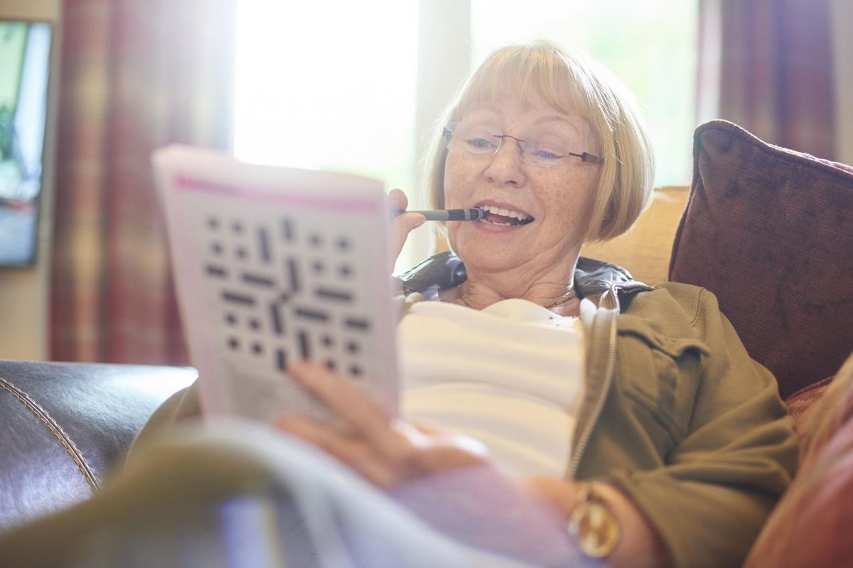 woman working on a crossword puzzle