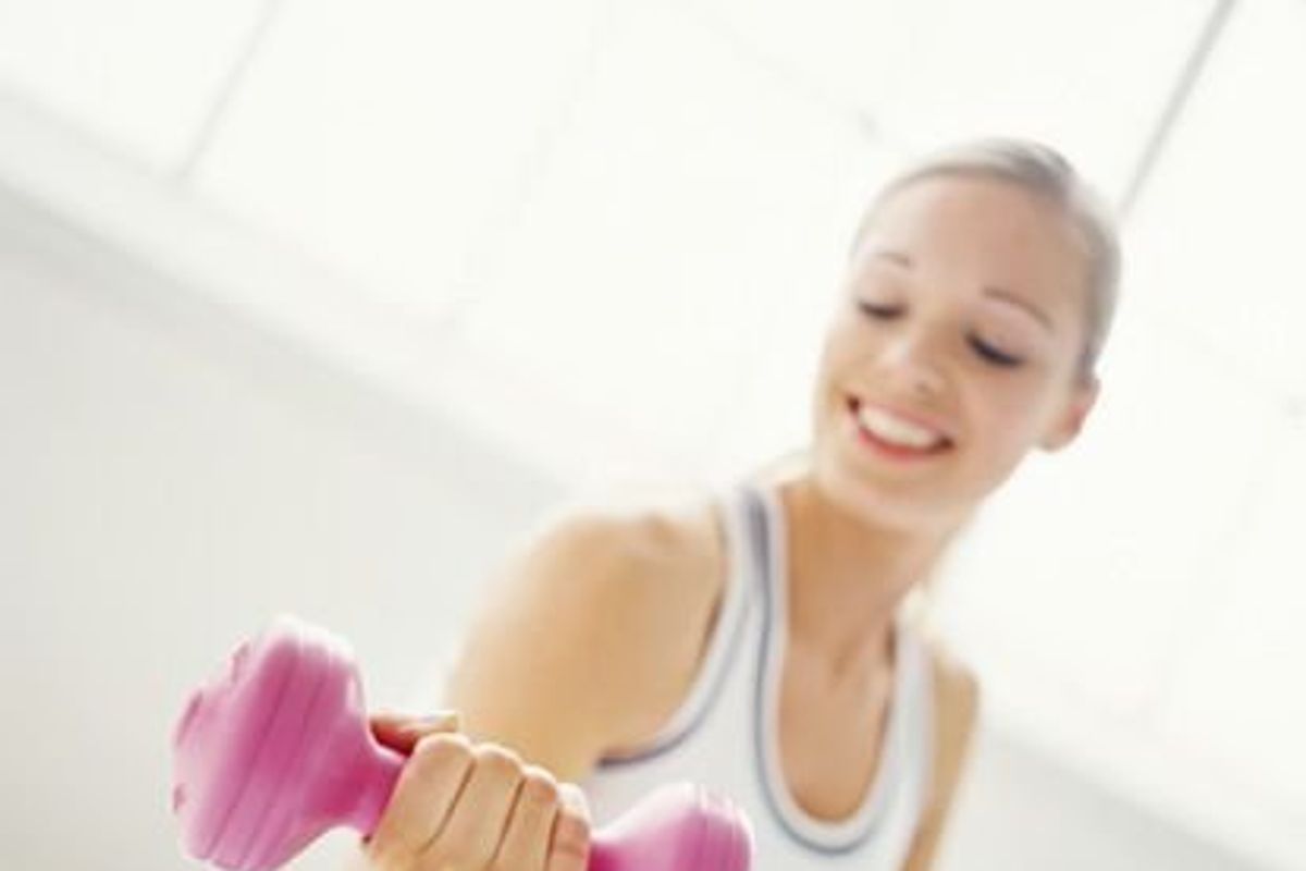woman working out with a dumbbell