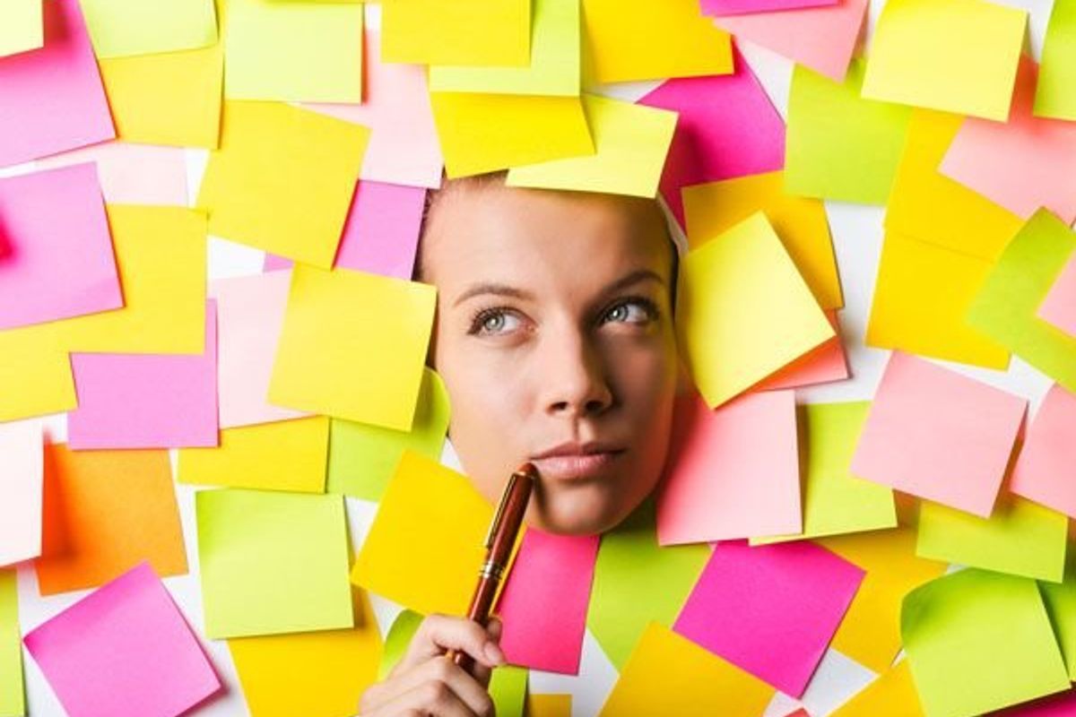 womans face among post-it notes