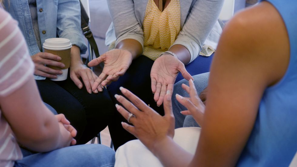 women gesturing during group therapy