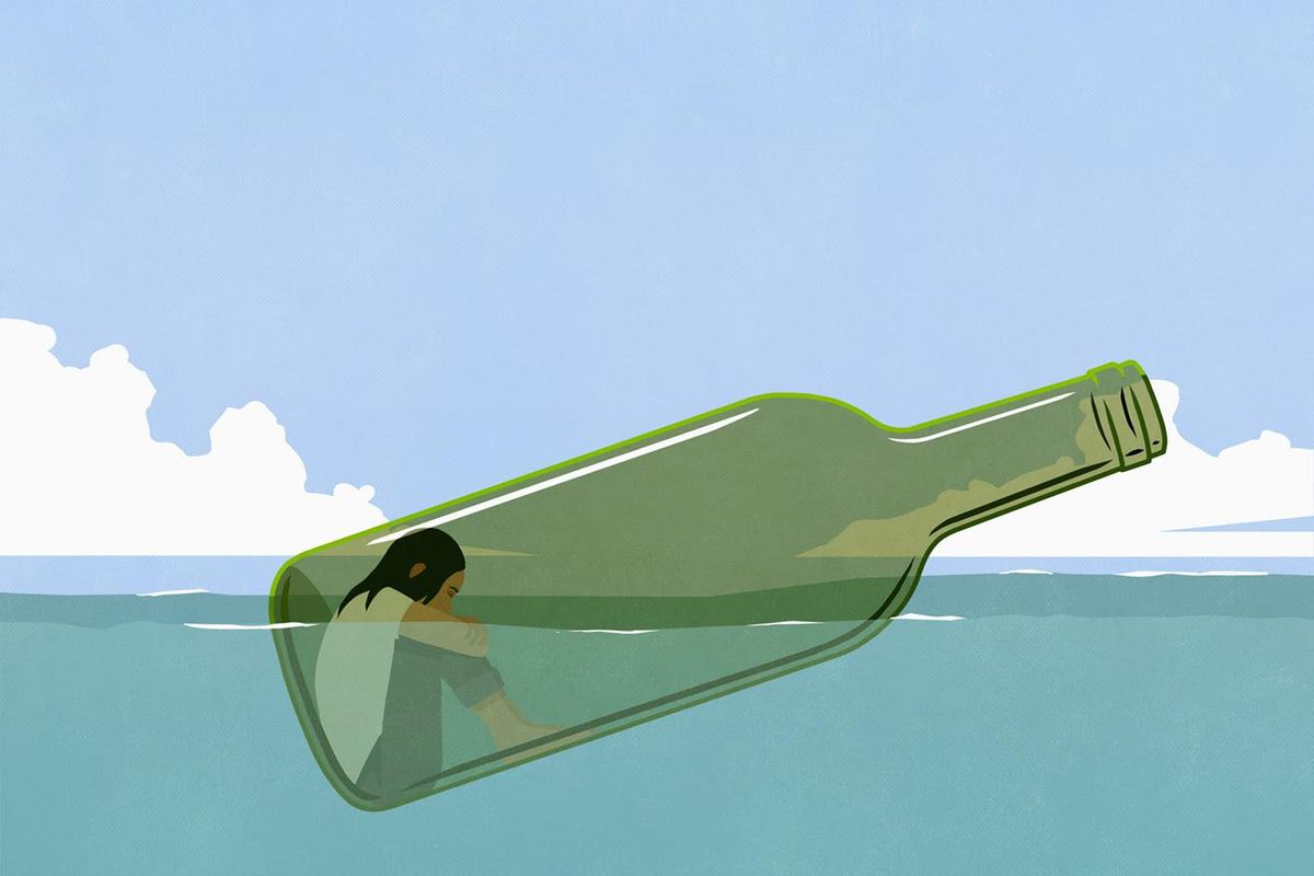 Women in a glass bottle floating in the ocean