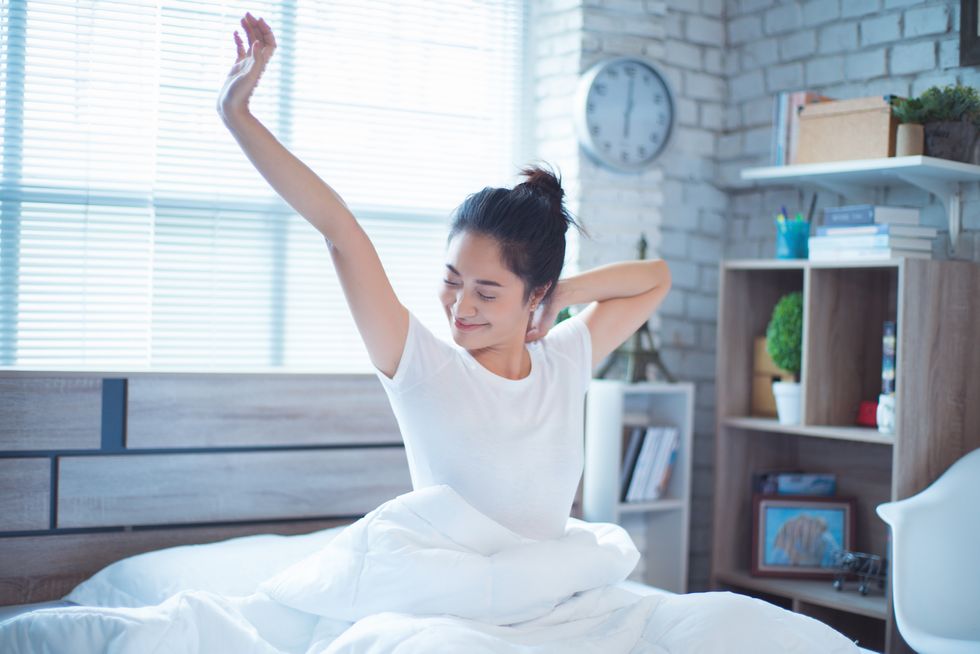 women is in bed and was waking up in the morning