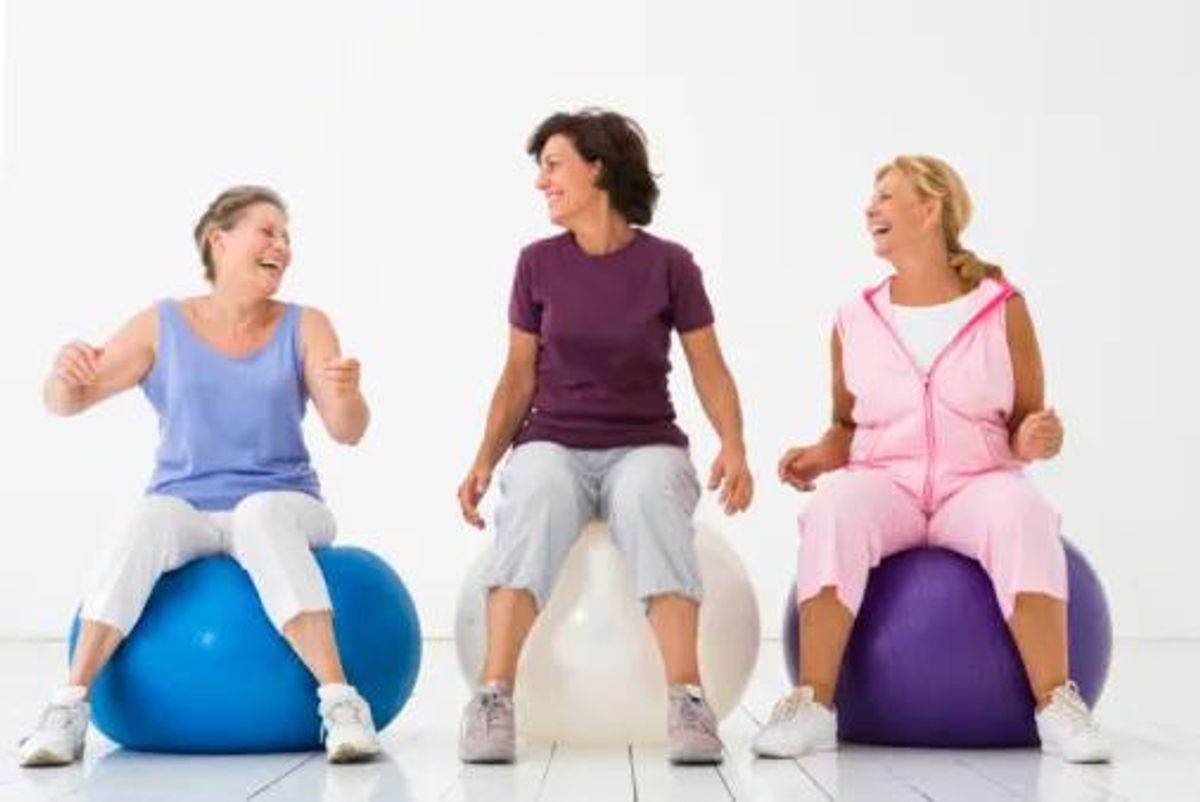 women laughing and working out together