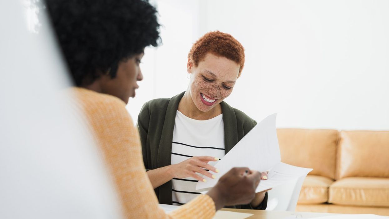 Women Reviewing Documents Together in Office