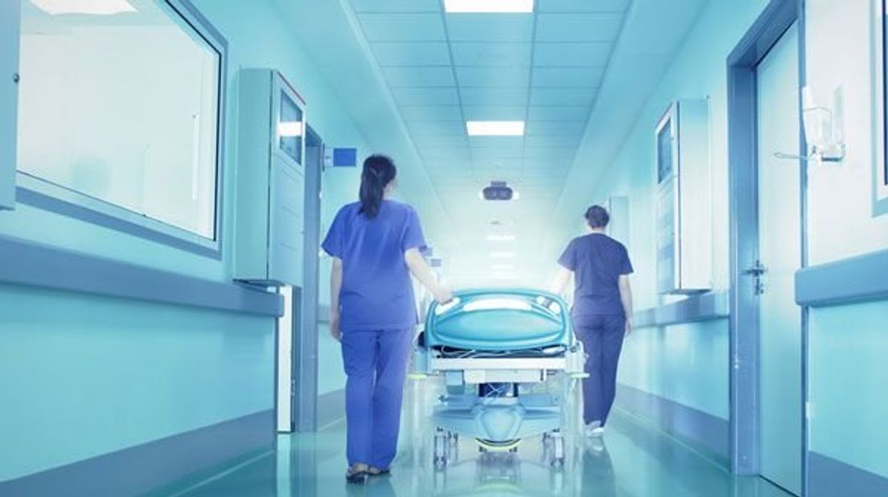 women walking a gurney down a hospital hallway waiting for a surgery