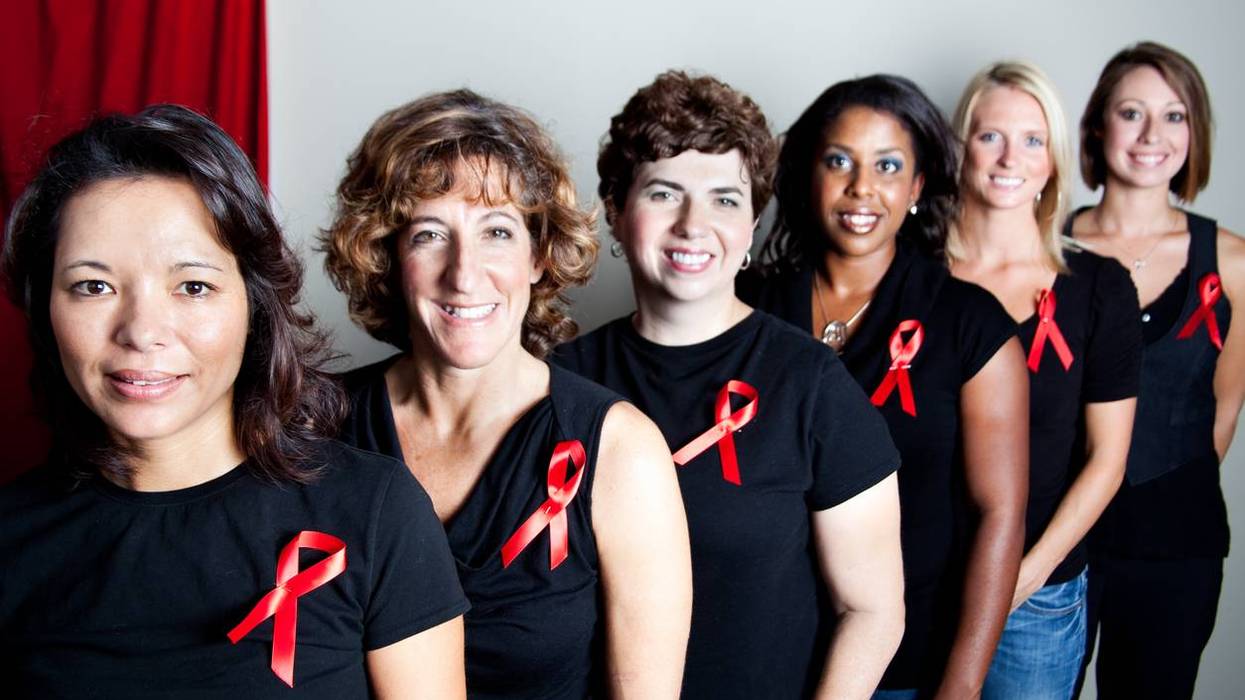 women wearing black shirts with aids awareness red ribbons