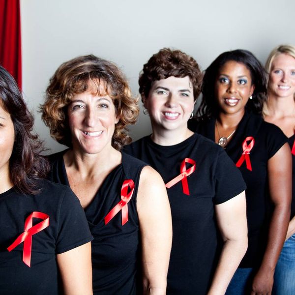 women wearing black shirts with aids awareness red ribbons